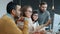 Slow motion of multi-ethnic group of people talking in office pointing at computer screen