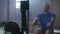 Slow motion: one men rower trains in a fitness room on a rowing machine