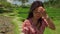 Slow motion outdoors lifestyle shot on young beautiful and happy Asian Chinese woman in stylish Summer dress walking on rice field
