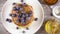 Slow motion pancakes for breakfast with berries and honey top view
