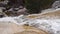 Slow motion panoramic view from above of a waterfall flowing. El Hornillo waterfall in Madrid Spain