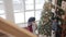 Slow motion of parents and child decorating New Year tree getting ready for winter holidays