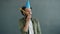 Slow motion portrait of Arab man wearing party hat blowing in horn smiling celebrating holiday