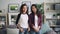 Slow motion portrait of attractive young women Asian and African American friends posing for camera standing at home