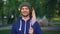 Slow motion portrait of bearded young man waving Spanish flag and looking at camera with happy smile standing in nice