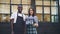 Slow motion portrait of beautiful multiracial couple cafe owners standing outside with we are open sign smiling and