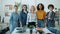 Slow motion portrait of diverse group of women standing in workplace with serious faces