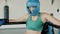 Slow motion portrait of female boxer wearing helmet gloves and sports bra standing in ring corner during break