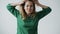 Slow motion portrait of furious young lady yelling and gesturing on white background