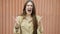 Slow motion portrait of furious young woman screaming expressing rage and aggression outdoors