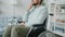 Slow motion portrait of handicapped man sitting in wheelchair in apartment