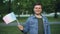 Slow motion portrait of handsome Frenchman proud patriot waving French flag with glad smile, looking at camera while