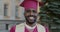 Slow motion portrait of happy African American student graduating from university smiling outdoors on campus