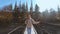 slow motion portrait of happy beautiful young woman tourist standing on wooden Suspension Bridge hanged over mountain