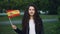 Slow motion portrait of happy Spanish woman proud patriot waving official flag of Spain looking at camera and smiling