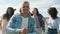 Slow motion portrait of joyful blond guys dancing on beach with friends smiling enjoying summertime