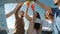 Slow motion portrait of joyful friends clinking bottles and drinking having fun on beach