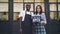 Slow motion portrait of man and woman business partners holding cafe open sign and smiling looking at camera. Starting