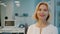 Slow motion portrait of mature blonde employee smiling in glass wall office