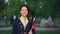 Slow motion portrait of pretty girl in casual clothes smiling and waving Belgian flag looking at camera happily. Young