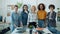 Slow motion portrait of successful businesswomen multi-ethnic team standing in office smiling