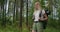 SLow motion: Portrait Traveling Happy Caucasian woman with backpack walking on path the tropical forest