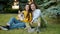 Slow motion portrait of young couple and corgi dog smiling relaxing in park