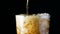Slow motion pouring cola soda rootbeer mixed water in to the glass with ice