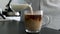 Slow Motion Pouring Milk Or Coffee Creamer In Black Coffee