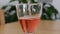 Slow motion of pouring of pink wine in the glass