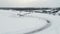 Slow motion of a racing cars championship sliding on an ice track. Clip. Winter drift competitions, aerial view.