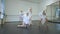 Slow motion rehearsal of four slim charming Caucasian women in dance studio. Beautiful concentrated confident talented