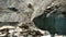 Slow motion rockfall in the mountains close up. Lumps of stones fall down from the melting glacier