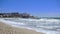 Slow motion sea waves breaking on a sandy beach in Costa dorada, Spain.