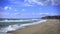 Slow motion sea waves breaking on a sandy beach in Costa dorada, Spain.