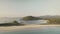 Slow motion seascape with boats at green mountain aerial. Sand beach, palm trees at hills on sea bay