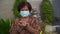 Slow-motion of senior woman wearing in medical masksurgical mask using alcohol gel to washing hand