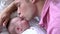 Slow Motion Sequence Of Father Kissing Baby Daughter In Bed