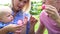 Slow Motion Sequence Of Parents Blowing Bubbles For Child