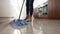Slow Motion Sequence Of Woman Mopping Kitchen Floor