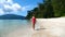 Slow Motion of Sexy Young Woman in Red Swimwear on Vacation Walking on Beach