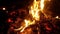 Slow-motion shooting of a fire flame on a night background. Burning firewood.