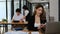 Slow motion shot of asian female accountant working with annual financial report, using calculator at office desk