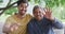 Slow motion shot of cheerful biracial father and son greeting while waving during video call