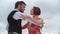 Slow motion shot of a couple of tango dancers dancing against a cloudy sky