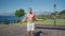 Slow motion shot of a man having cardio training outdoors and throwing skipping rope when finishing. Man doing jumping