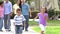 Slow Motion Shot Of Multi Generation Family Walking In Park