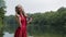 Slow motion shot. Portrait of girl with creative make-up in ethnic red dress