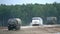 Slow motion shot of Russian Kamaz and Ural military trucks moving through obstacles