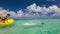 Slow motion shot of two boys jumping of canoe to tropical ocean